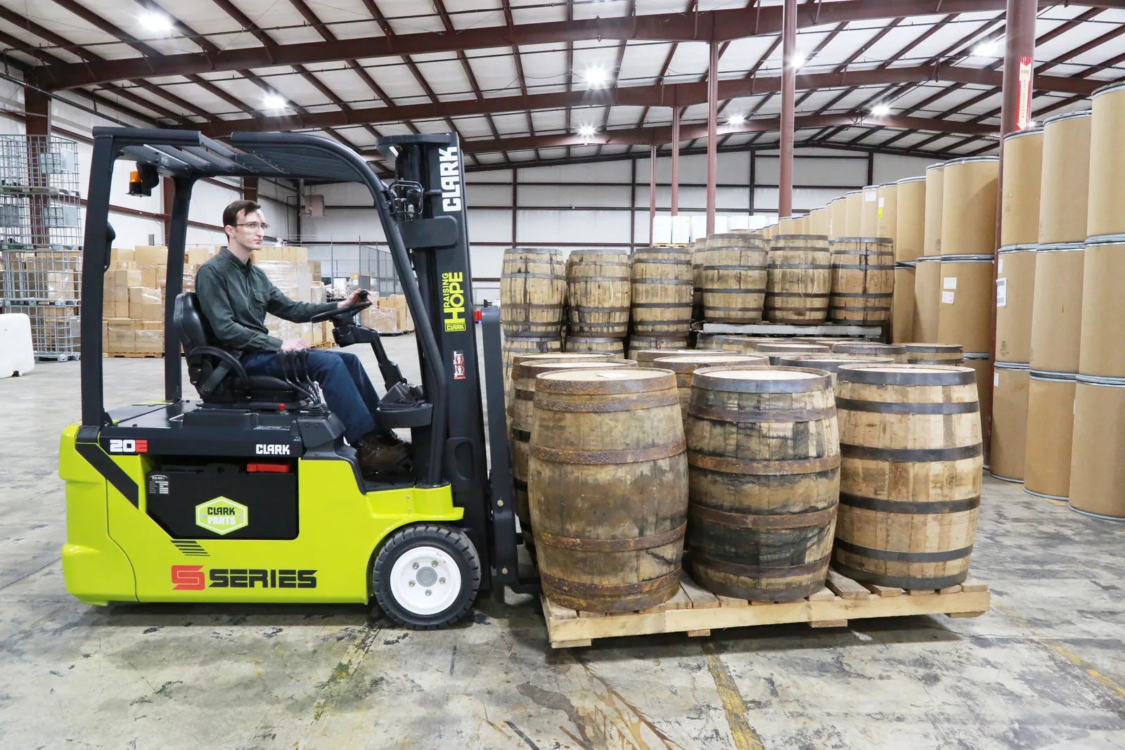 Clark S-Series electric forklift moving barrels in a Central PA warehouse