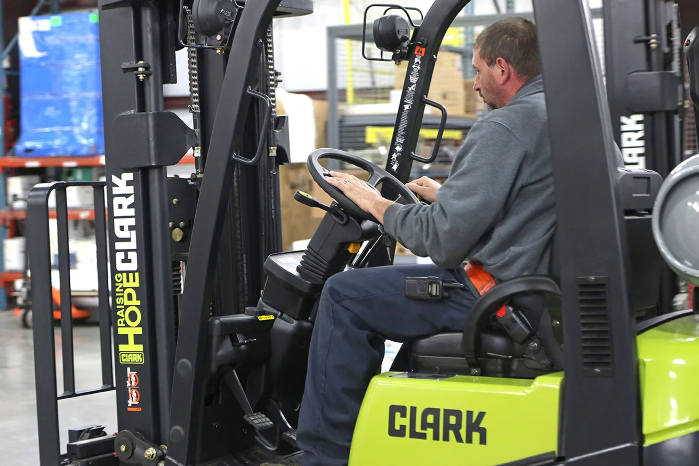 Operator at the controls of a Clark C15C forklift in a Central PA warehouse