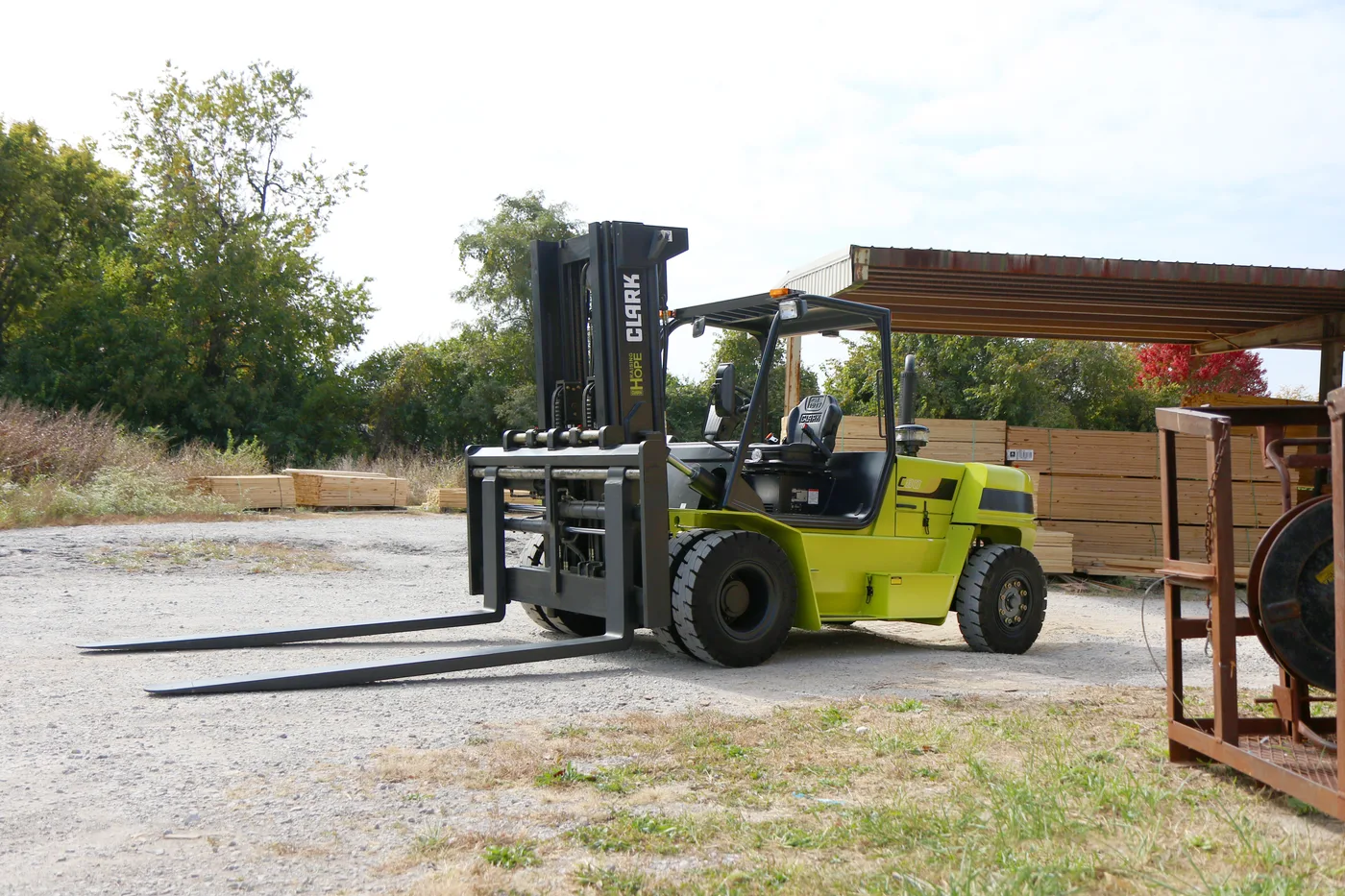 Heavy-capacity Clark pneumatic tire forklift working an outdoor lumber yard
